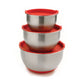 3 stainless steel mixing bowls in graduated sizes with red lids stacked on top of each other.