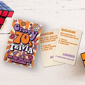 the groovy 70s trivia and two trivia cards displayed beside rubiks cubes on a white background