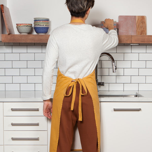 back view of person wearing apron.