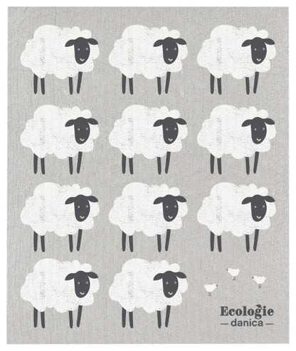 swedish dishcloth with grey background and sheep graphics on it.