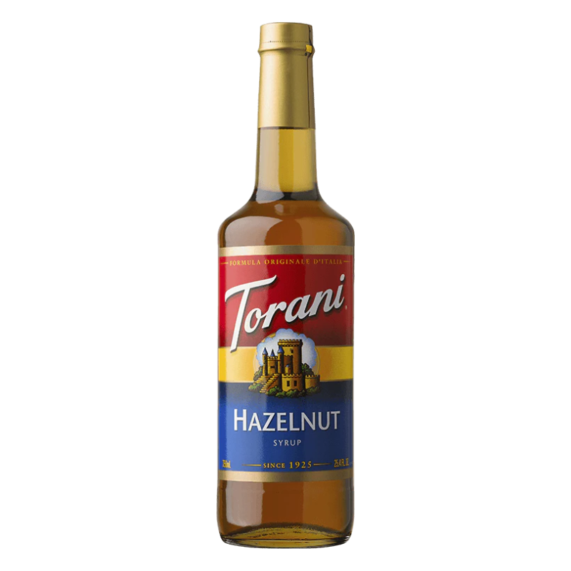 bottle of Torani Classic Hazelnut Syrup on white background.
