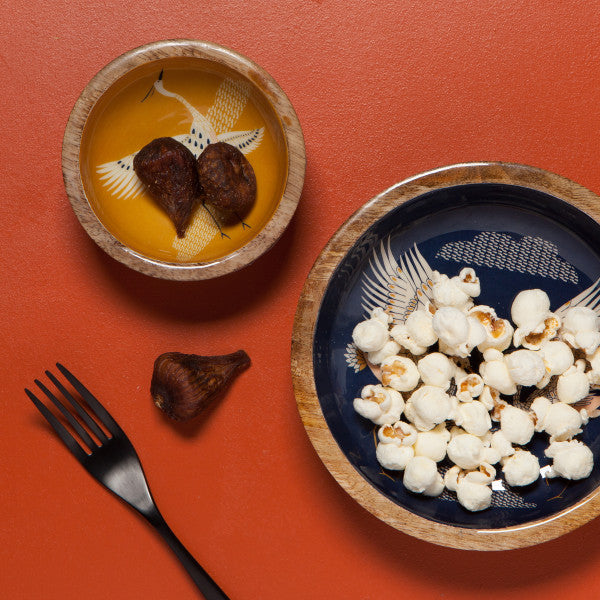 medium bowl filled with popcorn, mini bowl filled with figs.