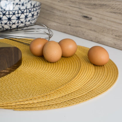 stack of placemats with eggs and whisk on them.