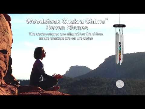 video of chime sound with woman meditating in mountains in the background.