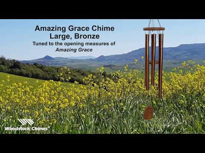 video of chime sound with flowers and mountains in background.
