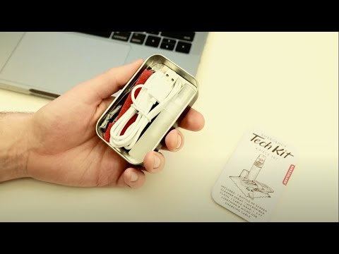video of a persons hands unpackaging the emergency tech kit and using it on the computer and the phone charging cord without sound
