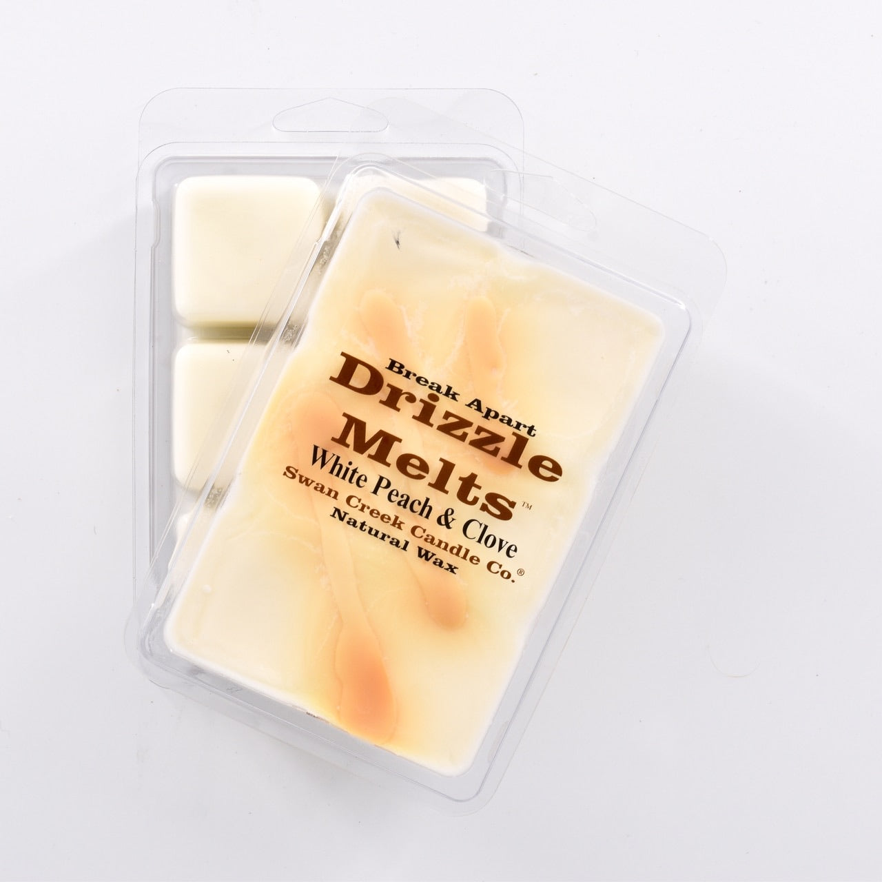 cream colored wax with caramel colored swirl across the top in packaging with another package showing the bottom of the wax melts break apart design.