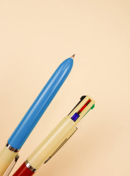 close up view of the red and blue vintage multi pen on a white background
