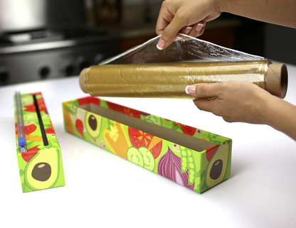 the veggie plastic wrap dispenser illustrating being used in a kitchen