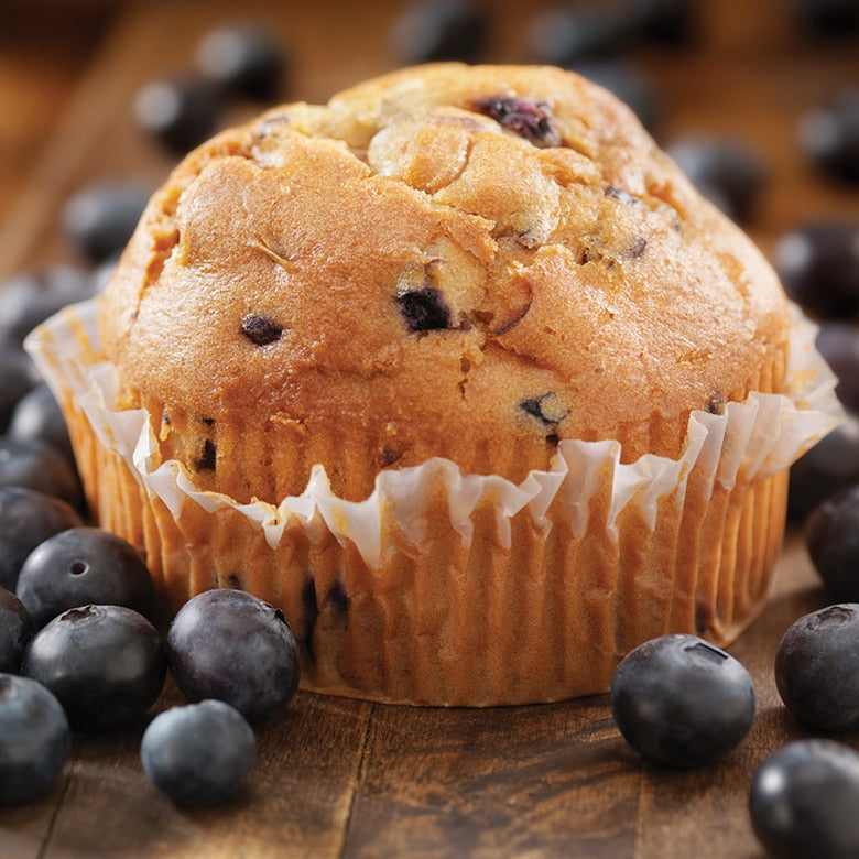 jumbo blueberry muffin surrounded by blueberries.