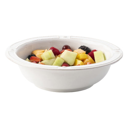 whitewashed berry and thread french panel serving bowl with fruit on a white background