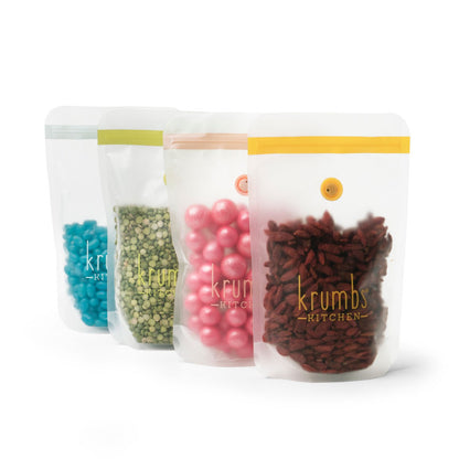 four essentials dry food storage bags with different candies in each on a white background