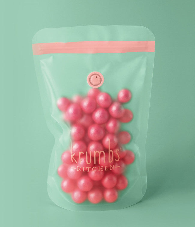 essentials dry food storage bag with pink candy inside on a turquoise background