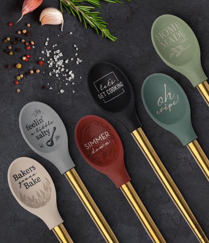 six elements spoons displayed on a gray table with spices