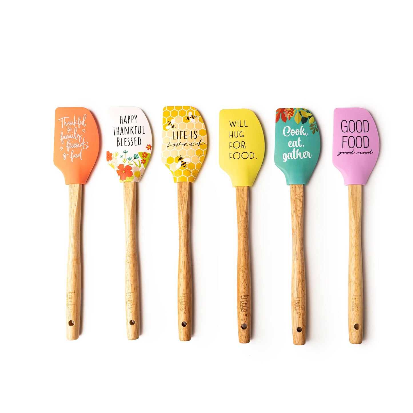 6 assorted silicone spatulas in a row on a white background.