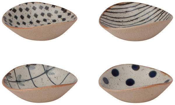 4 small bowls with curved rims, natural exteriors, and dark blue designs on the interior.