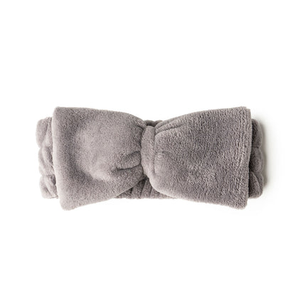 gray take a bow ultra spa headband rolled and displayed on a white background