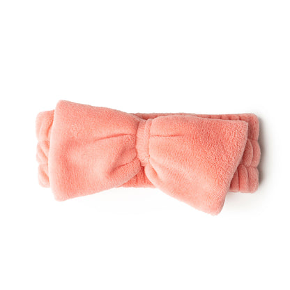 pink take a bow ultra spa headband rolled and displayed on a white background