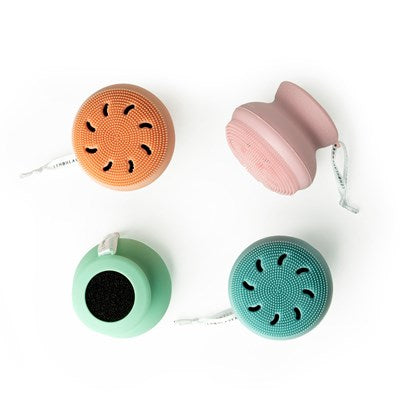 four different silicone body scrubbers displayed on a mostly white background