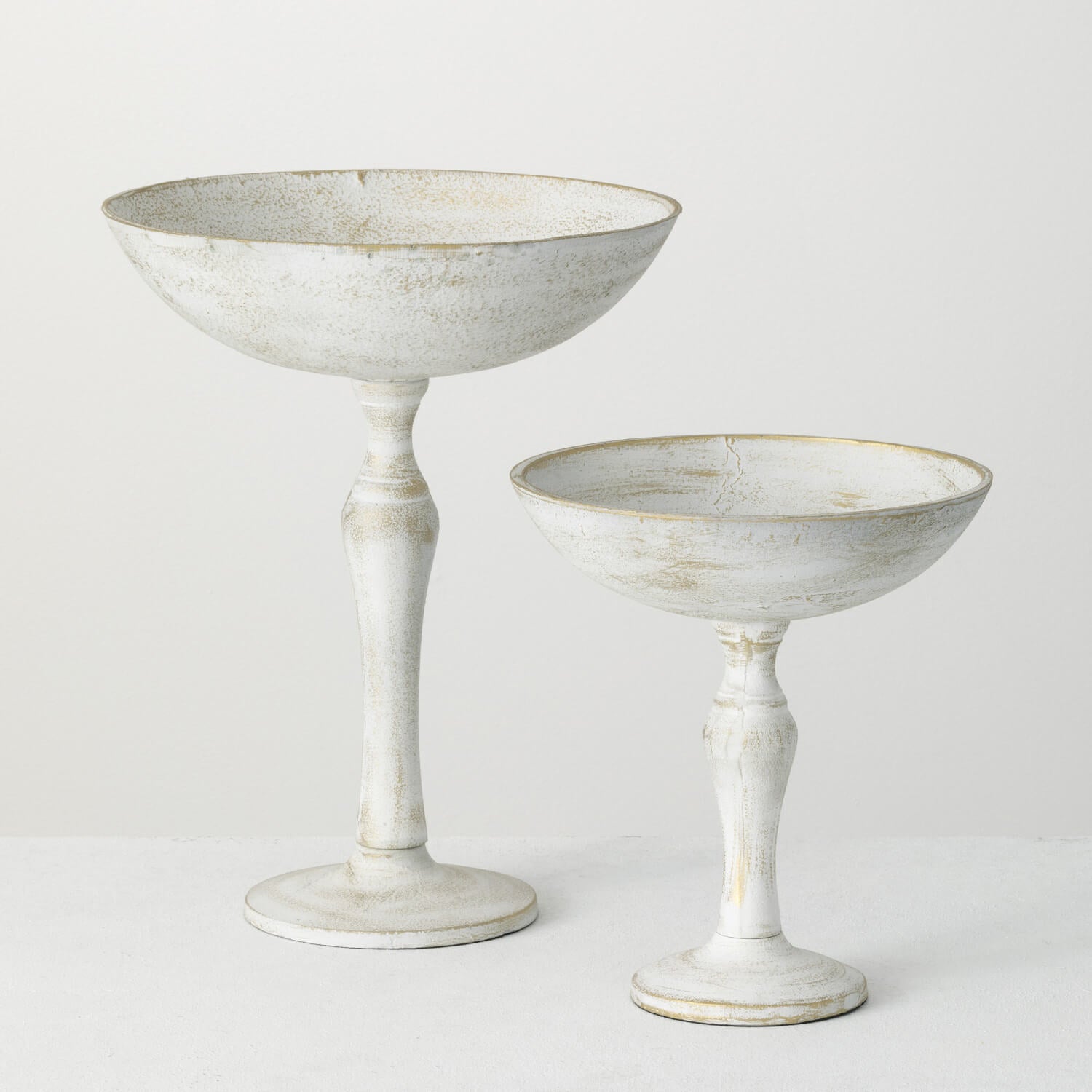small and large rustic pedestal bowls on a white background