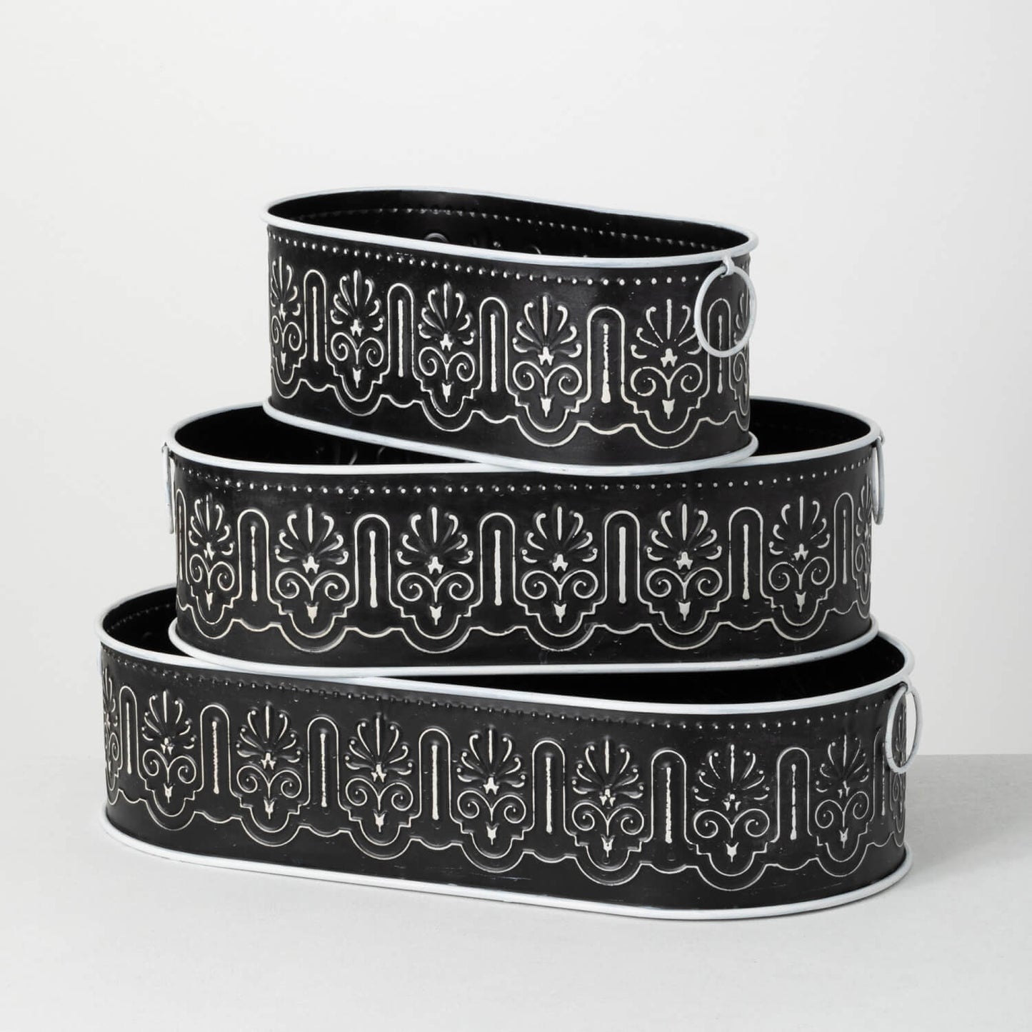small, medium, and large black oval buckets with white geometric designs.