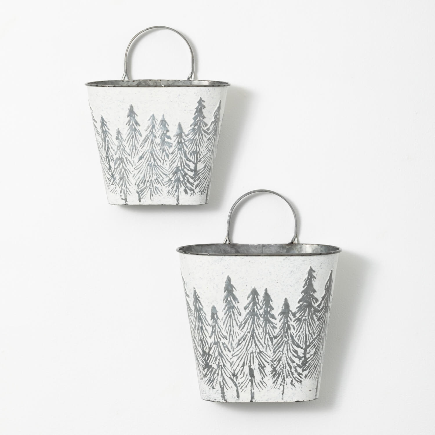 2 white buckets with a handle and tree designs on them.