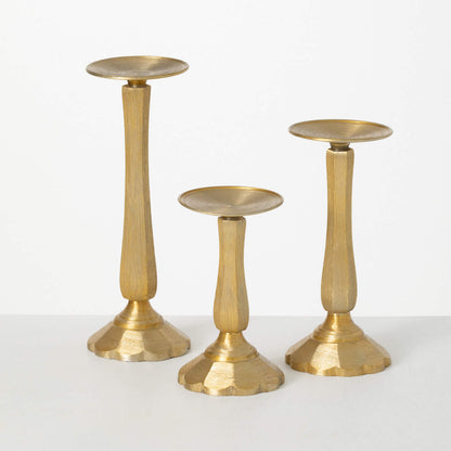 all three sizes of gilded classic pillar holders on a white background