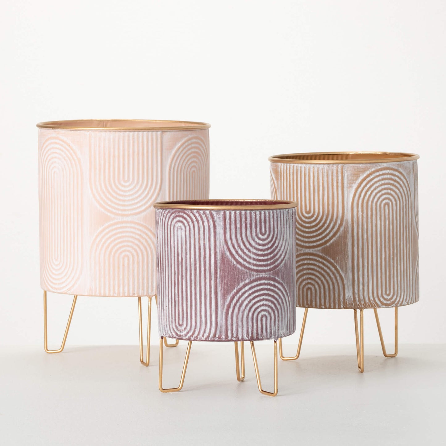 round metal planter with blush hues, retro geometric patterns, and gold hairpin legs.