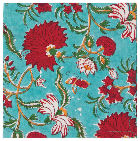 turquoise cloth napkin with f loral design in red, orange, and green.