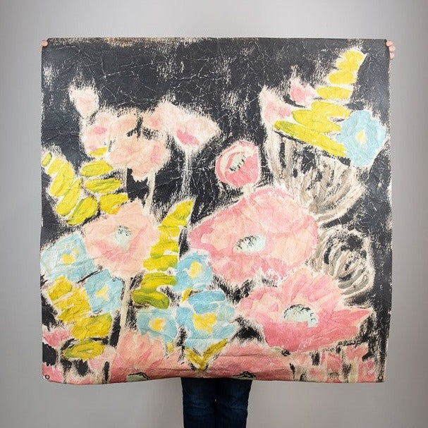 paper with black background and pink, yellow, and blue flowers printed on it.