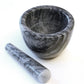 mortar with pestle next to it.