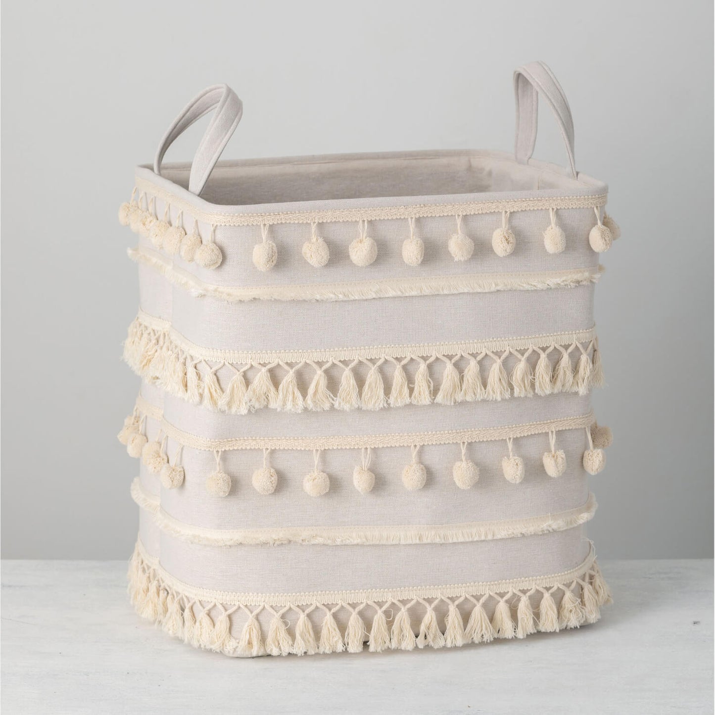 pom pom basket displayed on a white surface