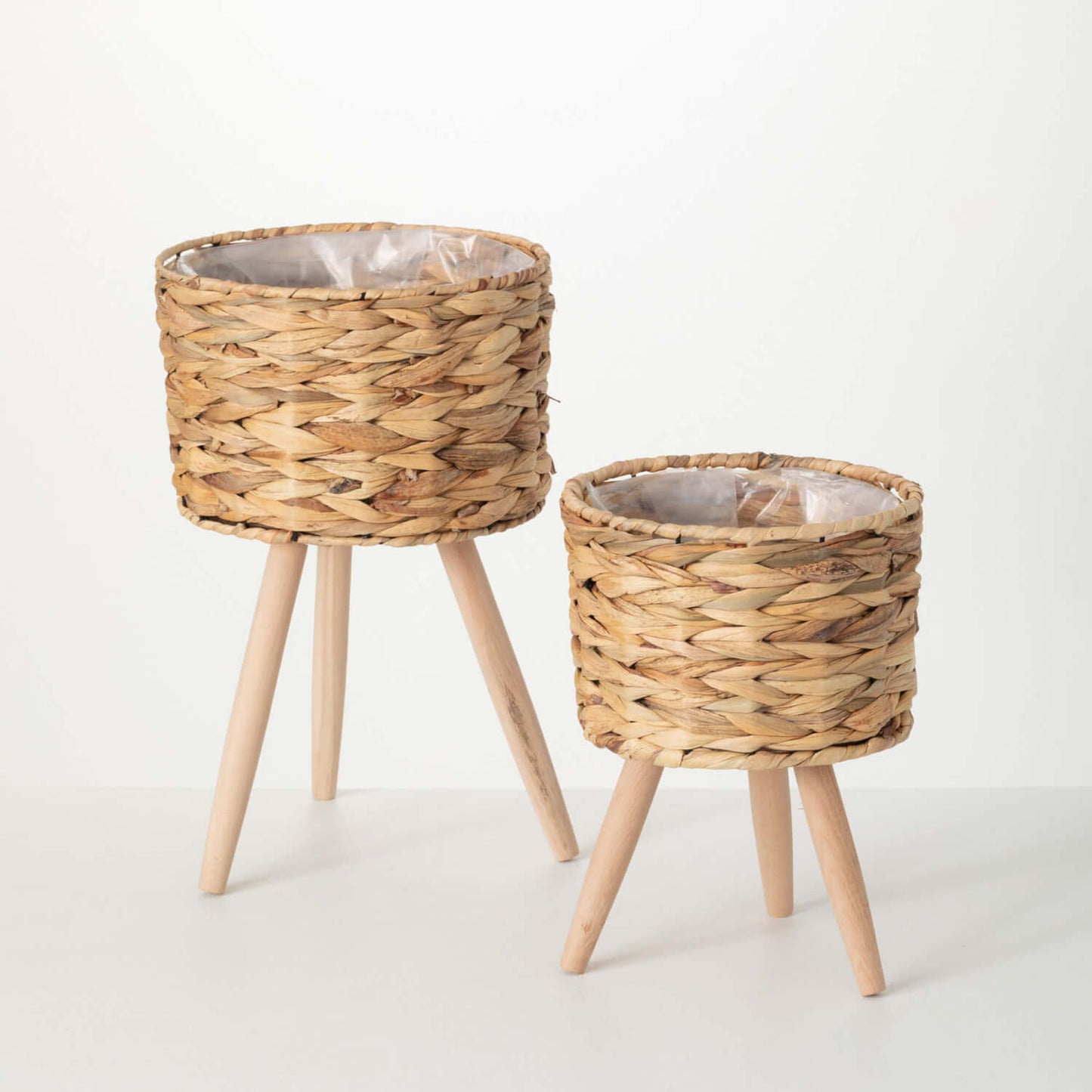 seagrass baskets with wooden legs on white background.