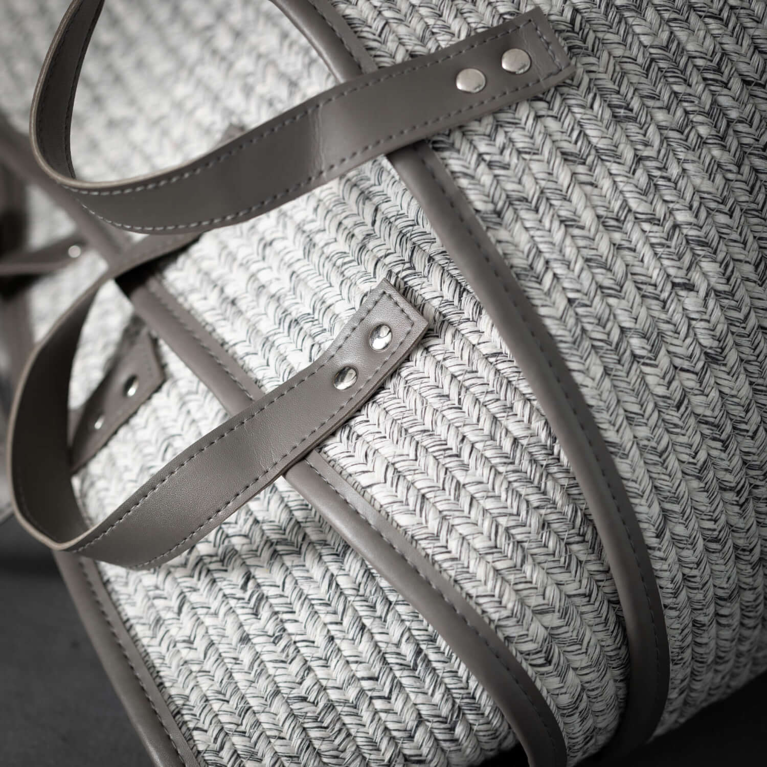 close up view of all three sizes of stacked dove gray woven textile baskets