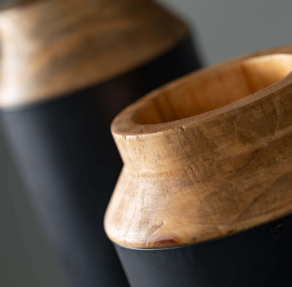 close up of the top of the metal and wood vases