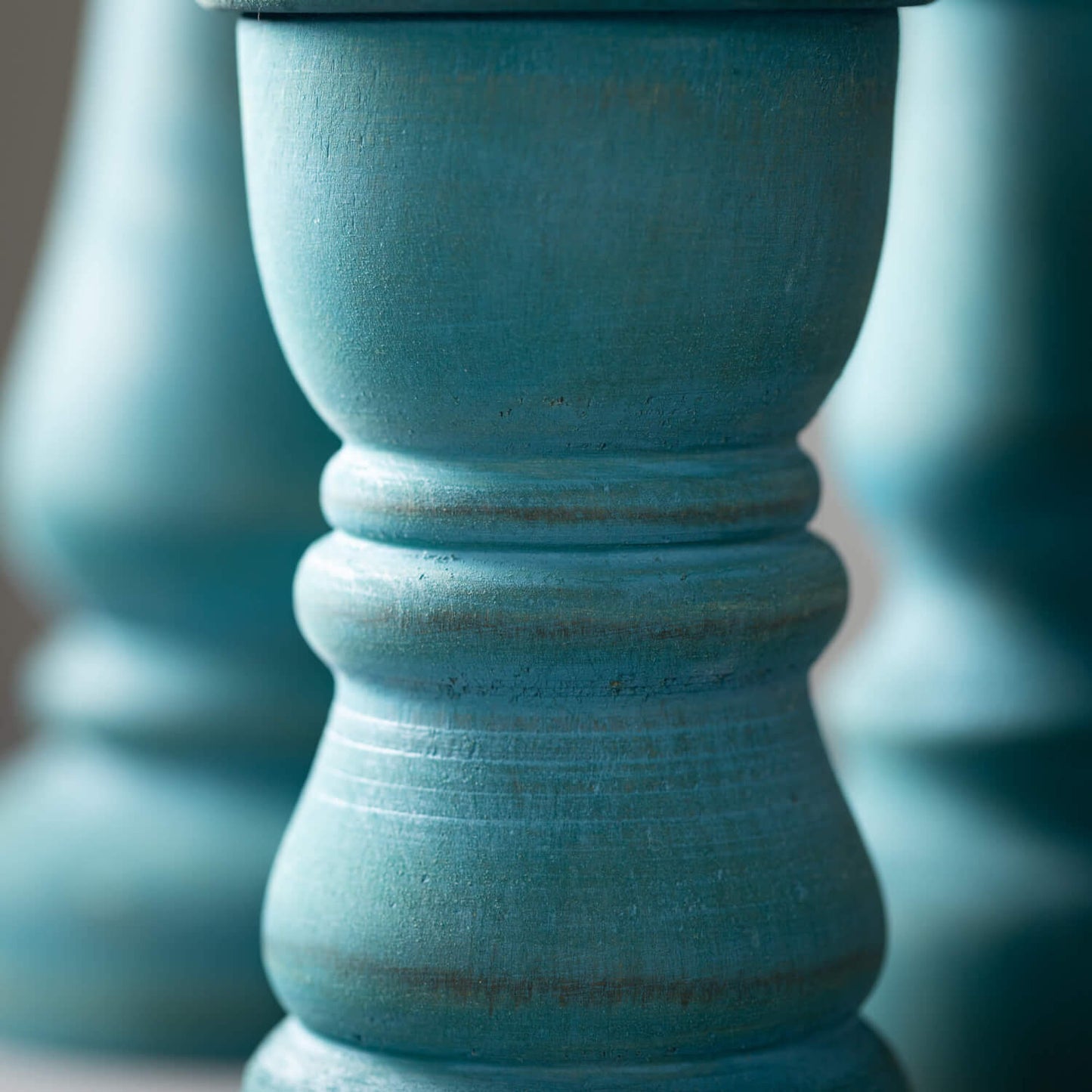 close-up of candle stick showing distressed finish.