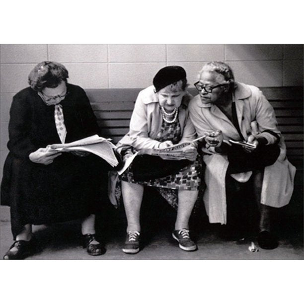front of card is a photograph of three women sitting on a bench reading the paper