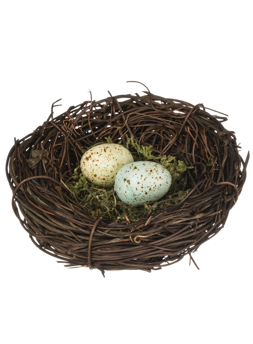 small brown twig nest with two eggs on a white background