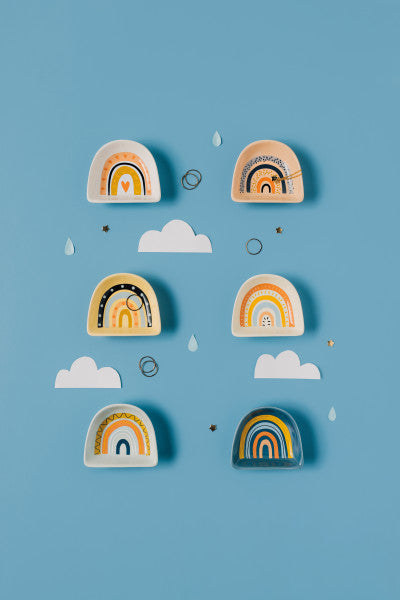 multiple style rainbow pinch bowls displayed with clouds on a blue background