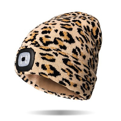 tan beanie with black and brown cheetah print and a light in the cuff.