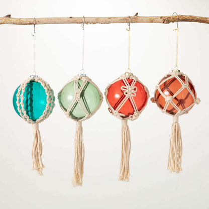 4 glass ornaments is assorted colors with macrame designs woven around them.