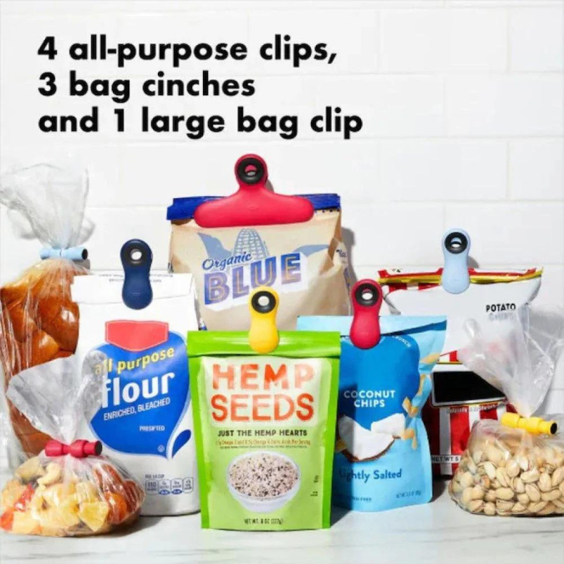 multple bags of packaged foods with the oxo clips holding them closed and the text "4 all-purpose clips, 3 bag cinches, and 1 large bag clip" on a white background.