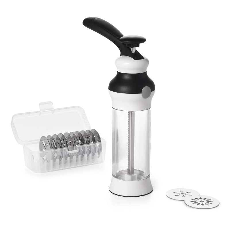 oxo cookie press with storage case and stainless steel cookie disks on a white background.