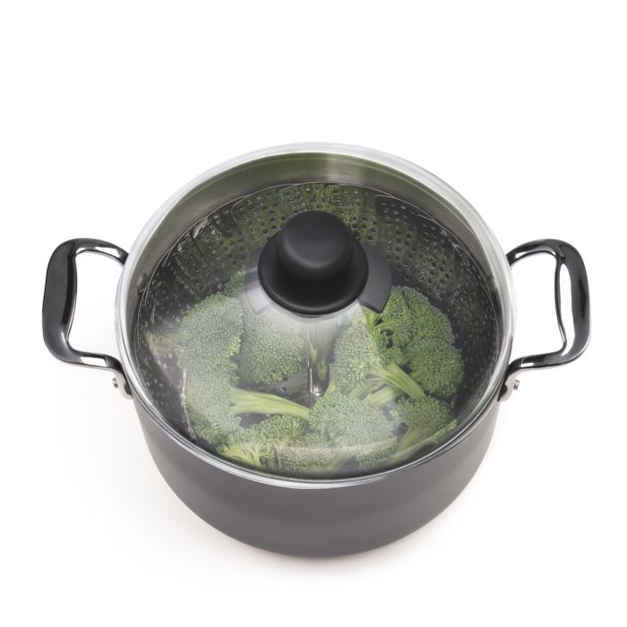steamer full of broccoli in pot with lid on it.