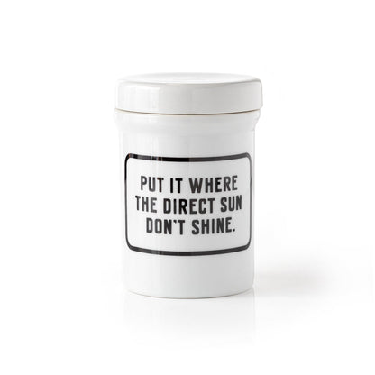 white planter with saucer and "put it where the direct sun don't shine" printed on it in black.