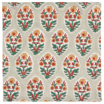 light grey napkin with yellow, green, and orange floral patterns.