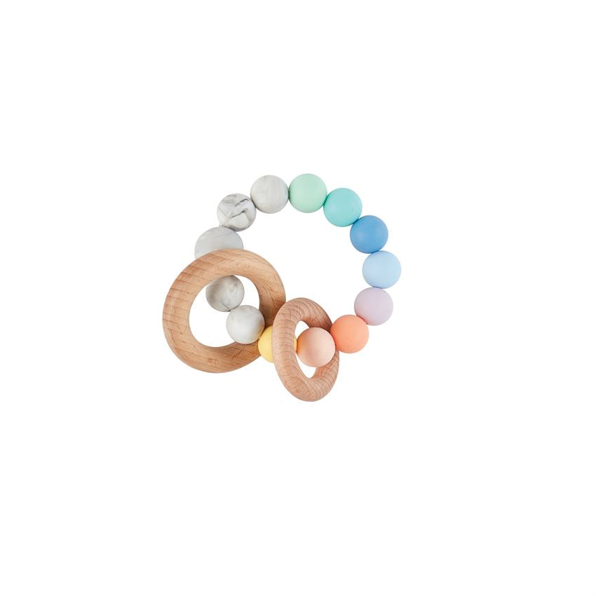 ring of silicone beads in rainbow colors with two wooden rings on it.