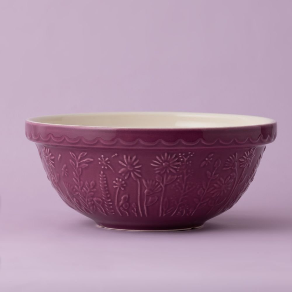 purple bowl with flower design on a lavender background.