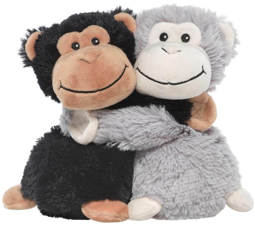 two plush monkeys hugging on white background.