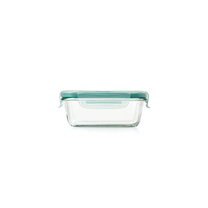 glass container with light green lid locked onto it.
